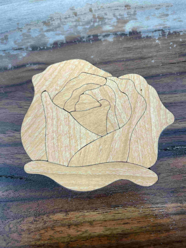 A wooden rose inlay offered by Slab Stitcher.