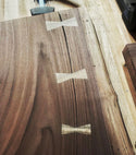 A medium wooden walnut bowtie inlay offered by Slab Stitcher