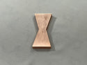 A single 1/4" Large Copper Metal Bowtie Inlay made by Slab Stitcher