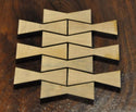 A small collection of maple wood bowtie inlays