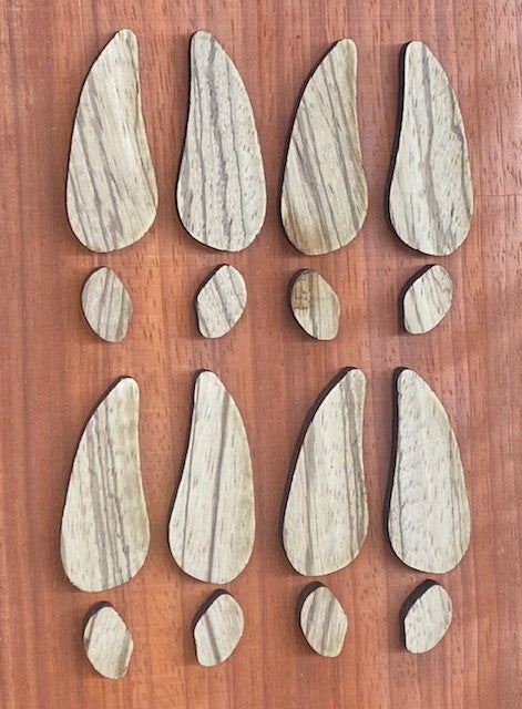 A four pack of 1/4" Zebrawood deer track inlays made by Slab Stitcher